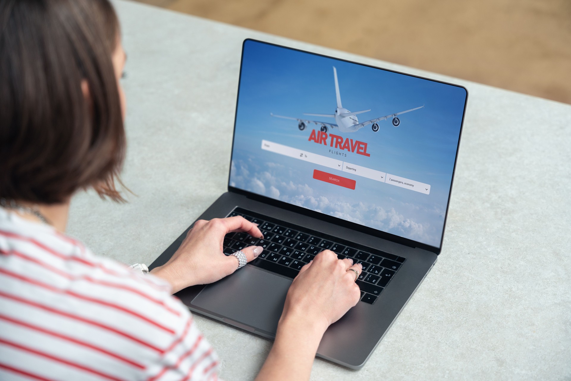 A woman uses laptop to search for airline tickets on the website